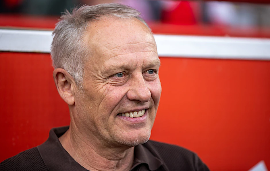 SC Freiburgs Trainer Christian Streich lacht.  