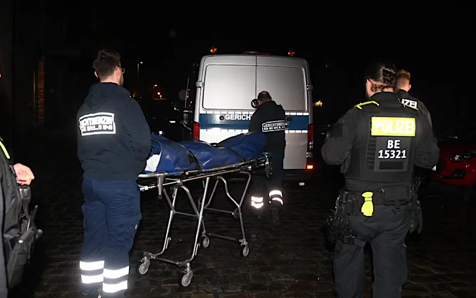Mitarbeiter der Gerichtsmedizin transportieren eine Leiche ab, die in dem Wohnungsbordell gefunden wurde.