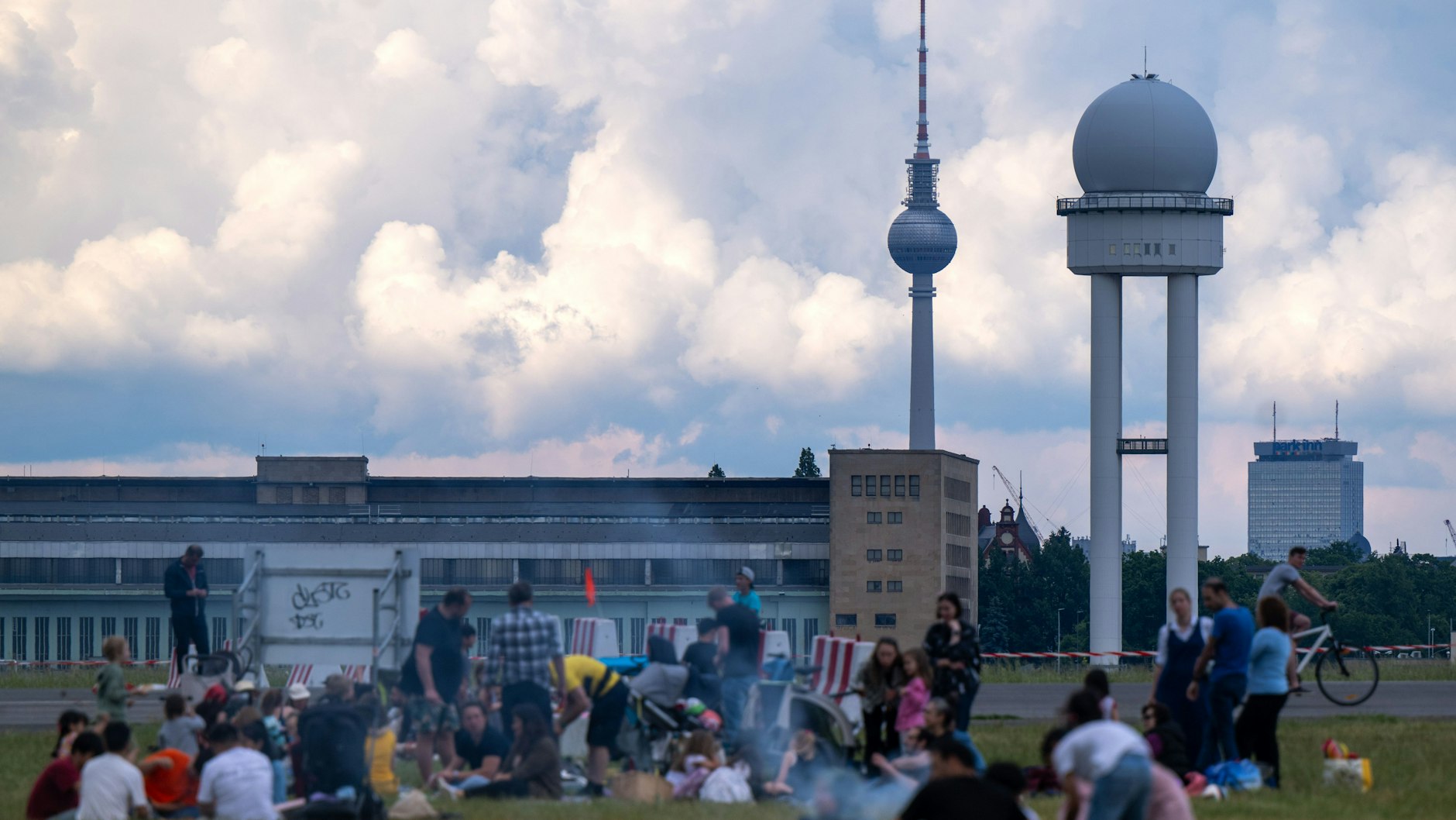 Zahlreiche Berliner grillen bei sommerlichen Temperaturen auf einem Grillplatz auf dem Tempelhofer Feld.