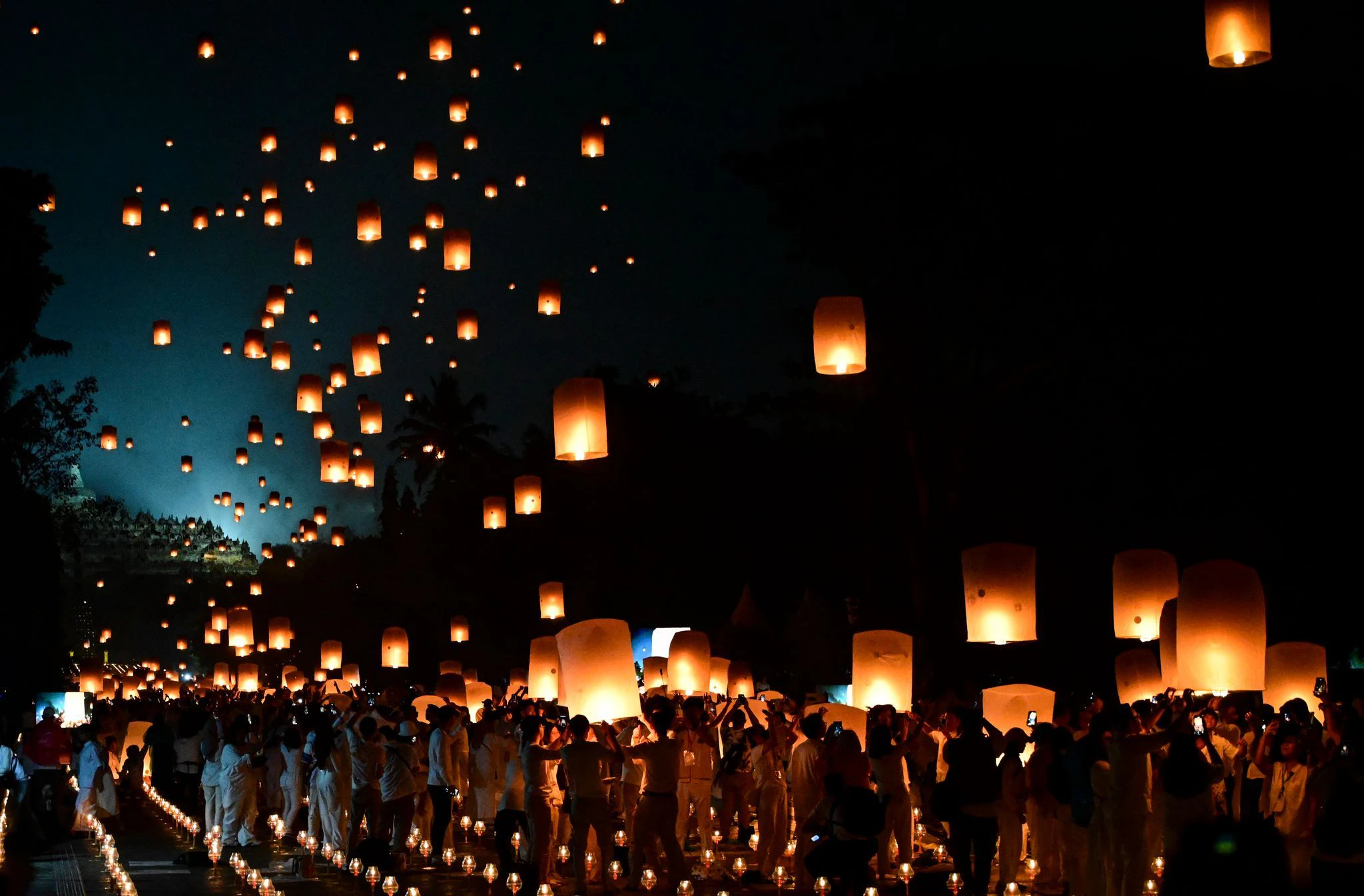Menschen lassen während der Feierlichkeiten zum Vesak-Tag am Borobudur-Tempel im indonesischen Magelang Himmelslaternen los.  