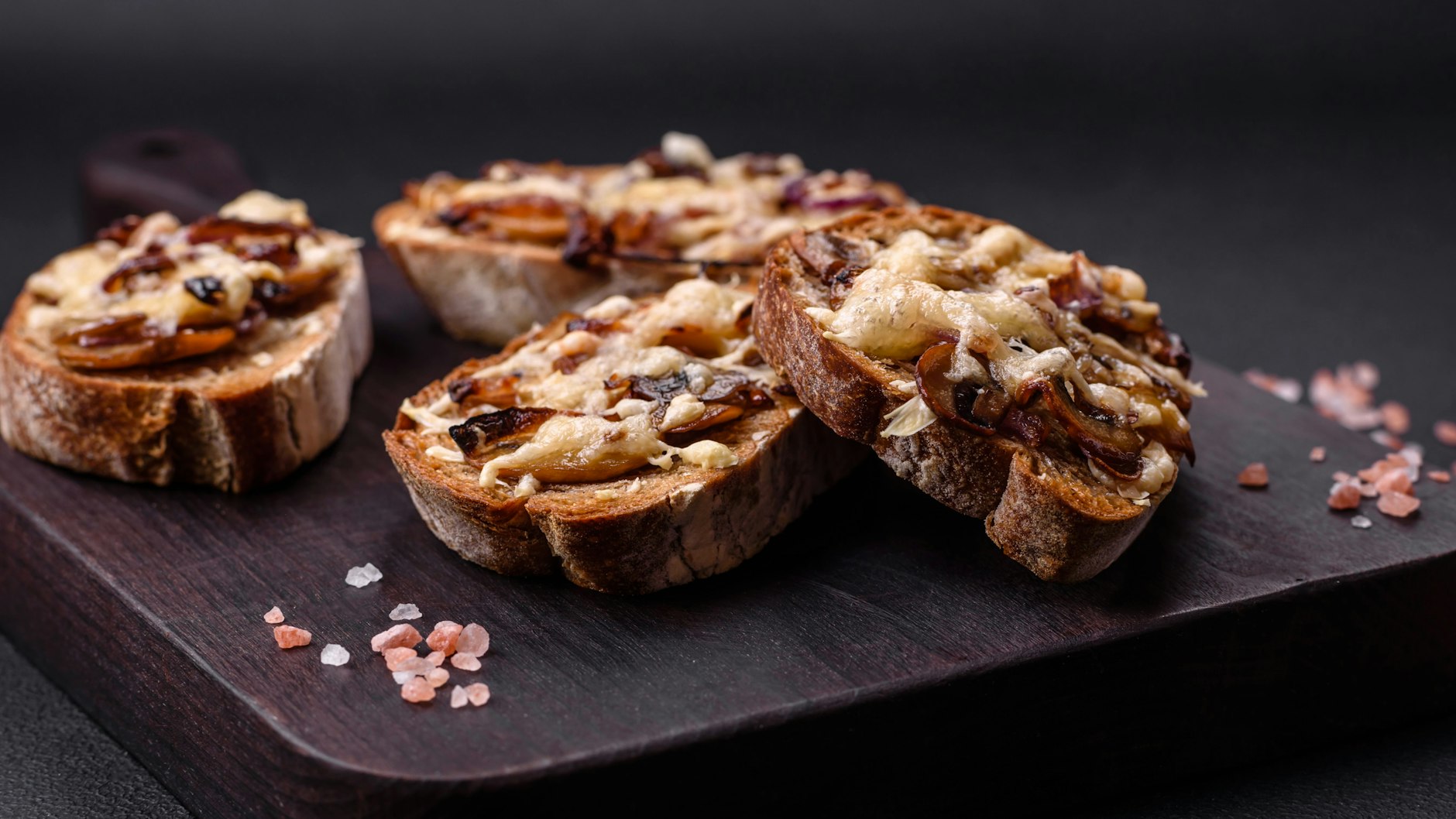 Wer mag, bestreut das fertige Champignon-Bruschetta noch mit Käse - das verfeinert das Rezept zusätzlich.