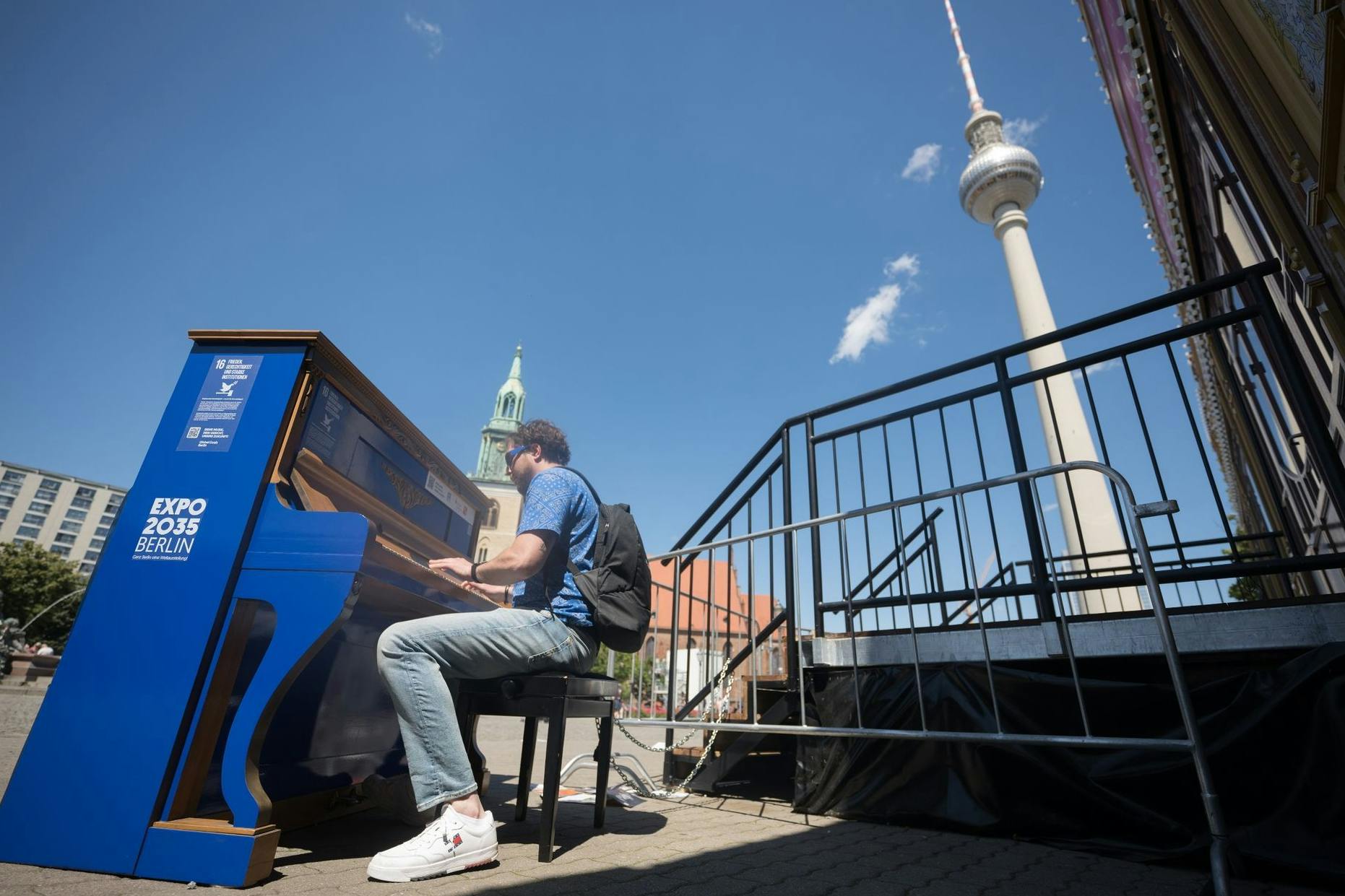 Ein Mann spielt das Global-Goals-Klavier Nr. 16 – „Frieden, Gerechtigkeit und starke Institutionen“ –, das anlässlich der Europawahl in Deutschland in Sichtweite des Fernsehturms steht. 