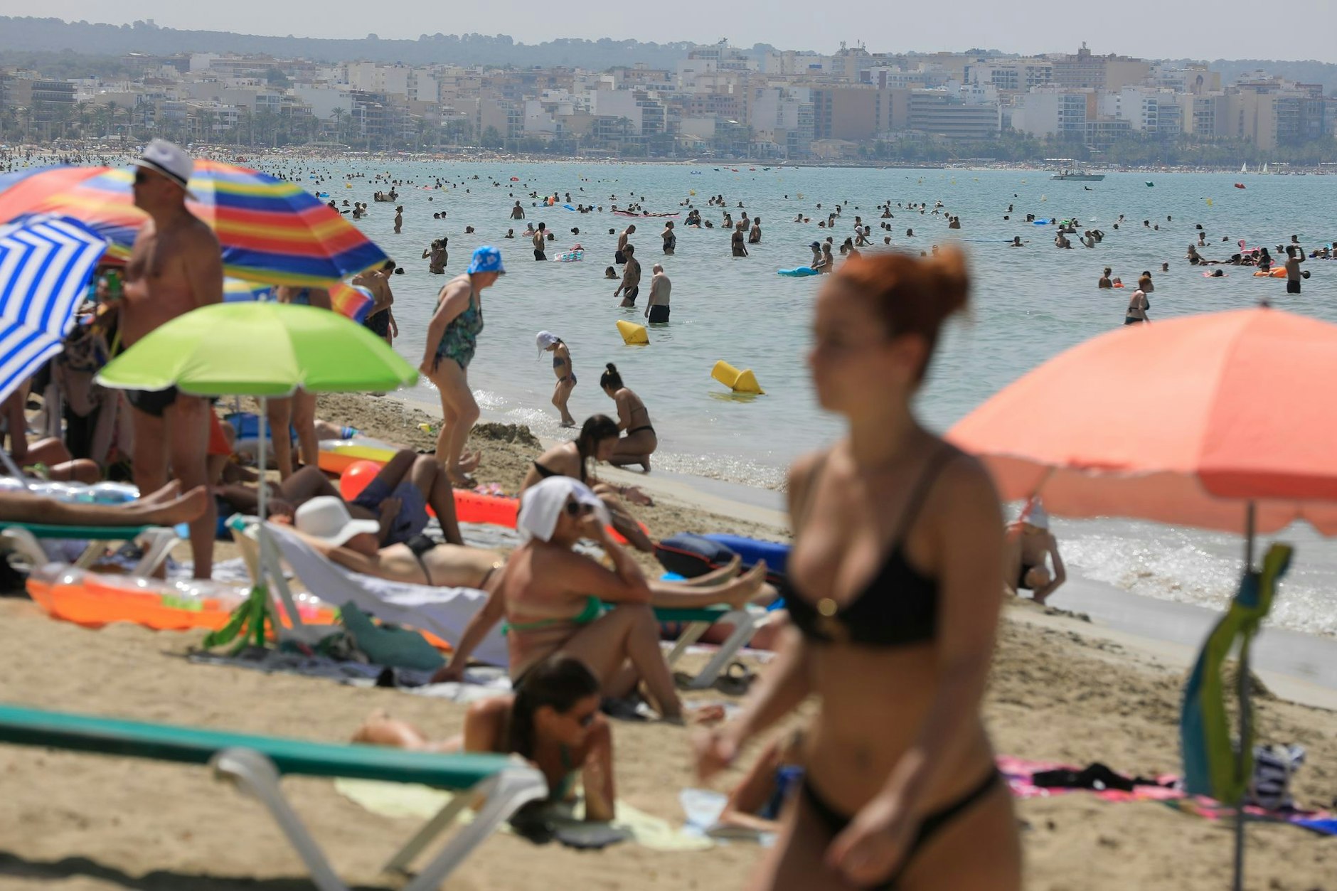 Menschen schwimmen und sonnen sich am Strand von Arenal der Mittelmeer-Insel Mallorca.&nbsp;