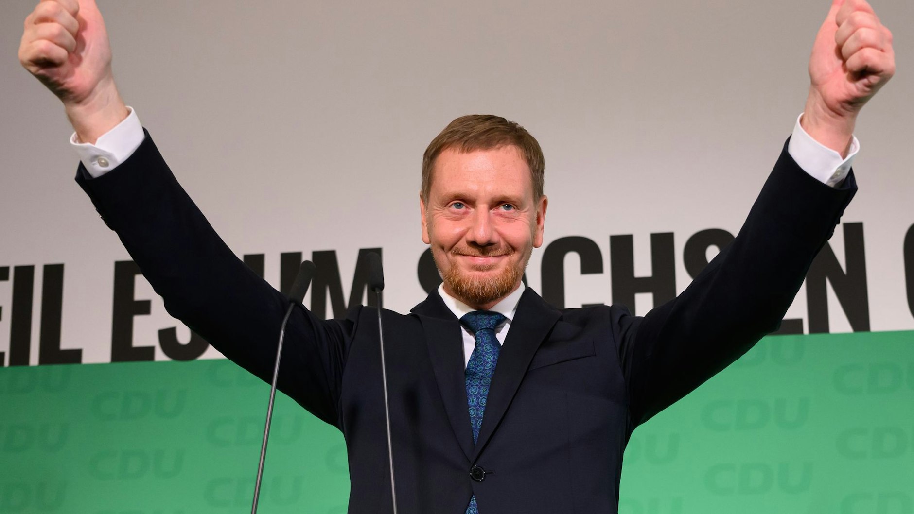 Michael Kretschmer (CDU), incumbent Prime Minister of Saxony and top candidate, waves on stage after the announcement of the first projections.