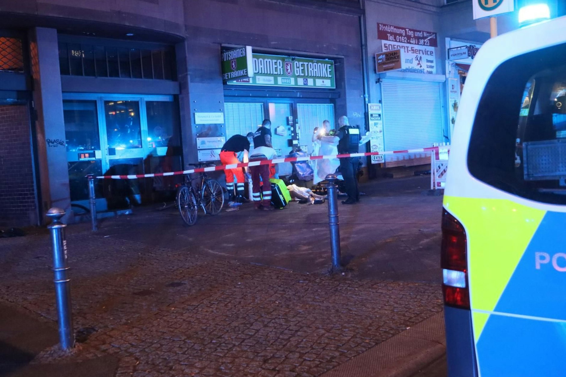 Rettungskräfte kümmern sich nach einer Schießerei in Schöneberg um einen Verletzten.