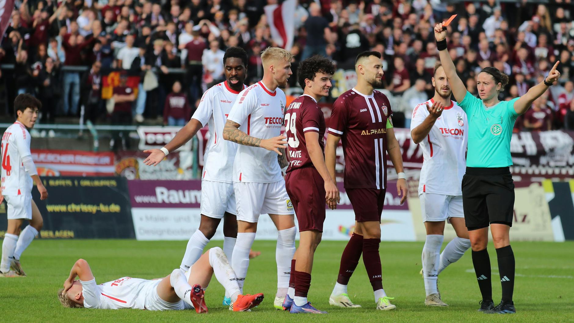 Schiedsrichterin Franziska Wildfeuer (r.) hat gar keine Wahl, schickt Henry Crosthwaite (M.) nach seinem Tritt nach hinten mit Rot vom Platz.