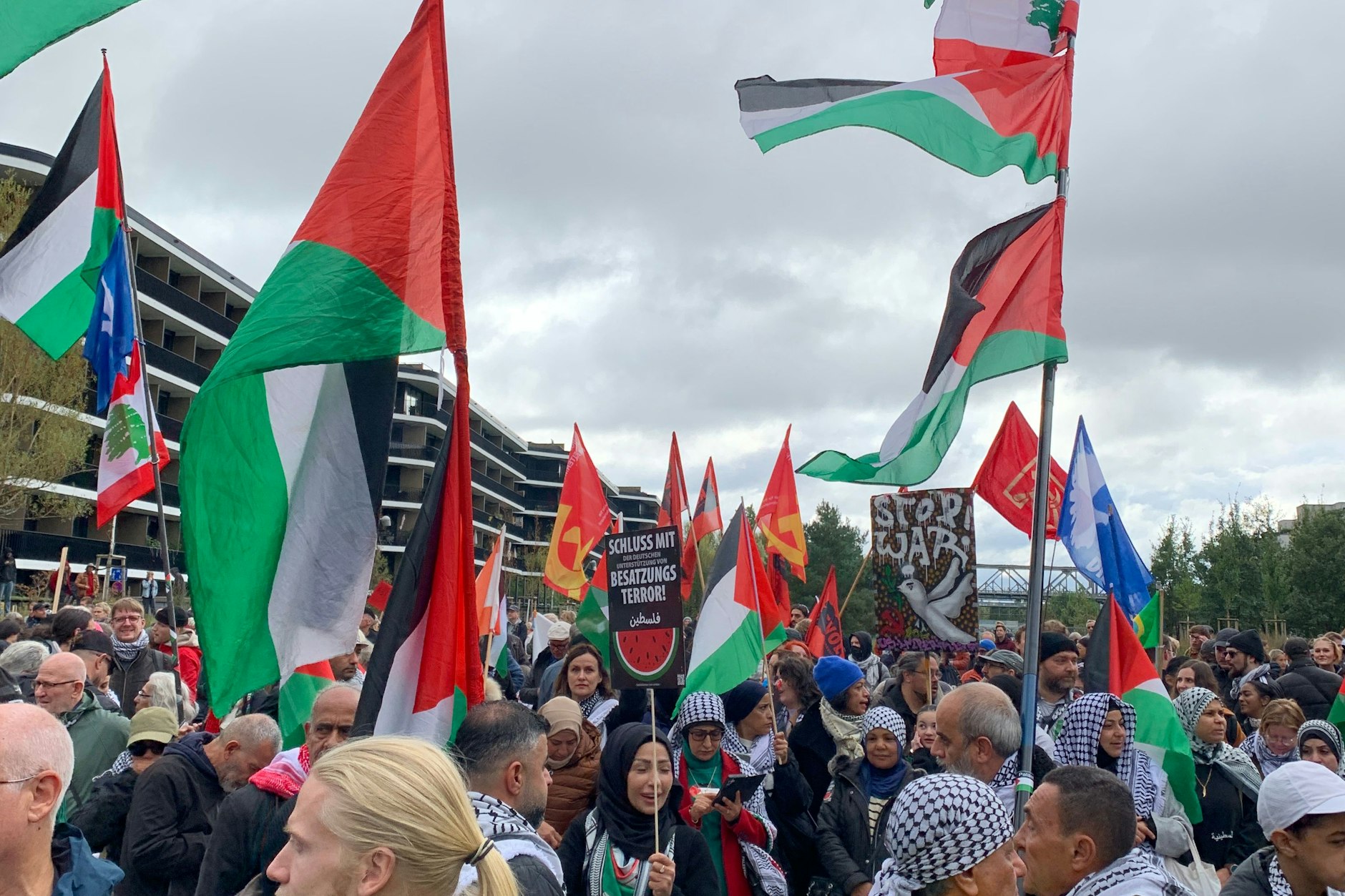 Am Mendelssohn-Bartholdy-Park stehen einige Dutzend propalästinensischer Demonstranten inmitten der Teilnehmer der Friedensdemo.