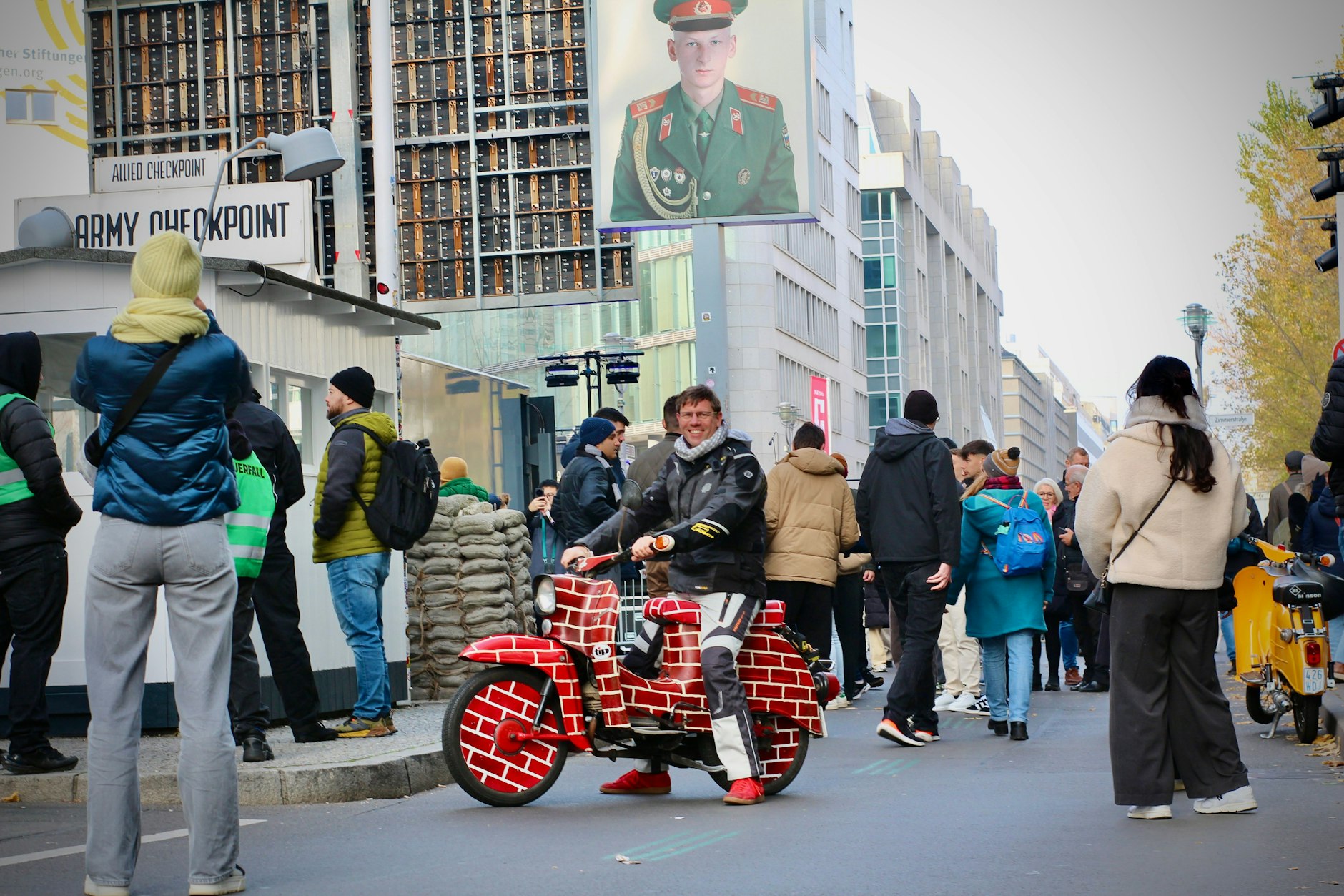 Felix Waury am Checkpoint Charlie mit seiner kunstvoll bemalten Schwalbe aus den 80er-Jahren – der gut gepflegte Zweitakter funktioniert noch wunderbar! 