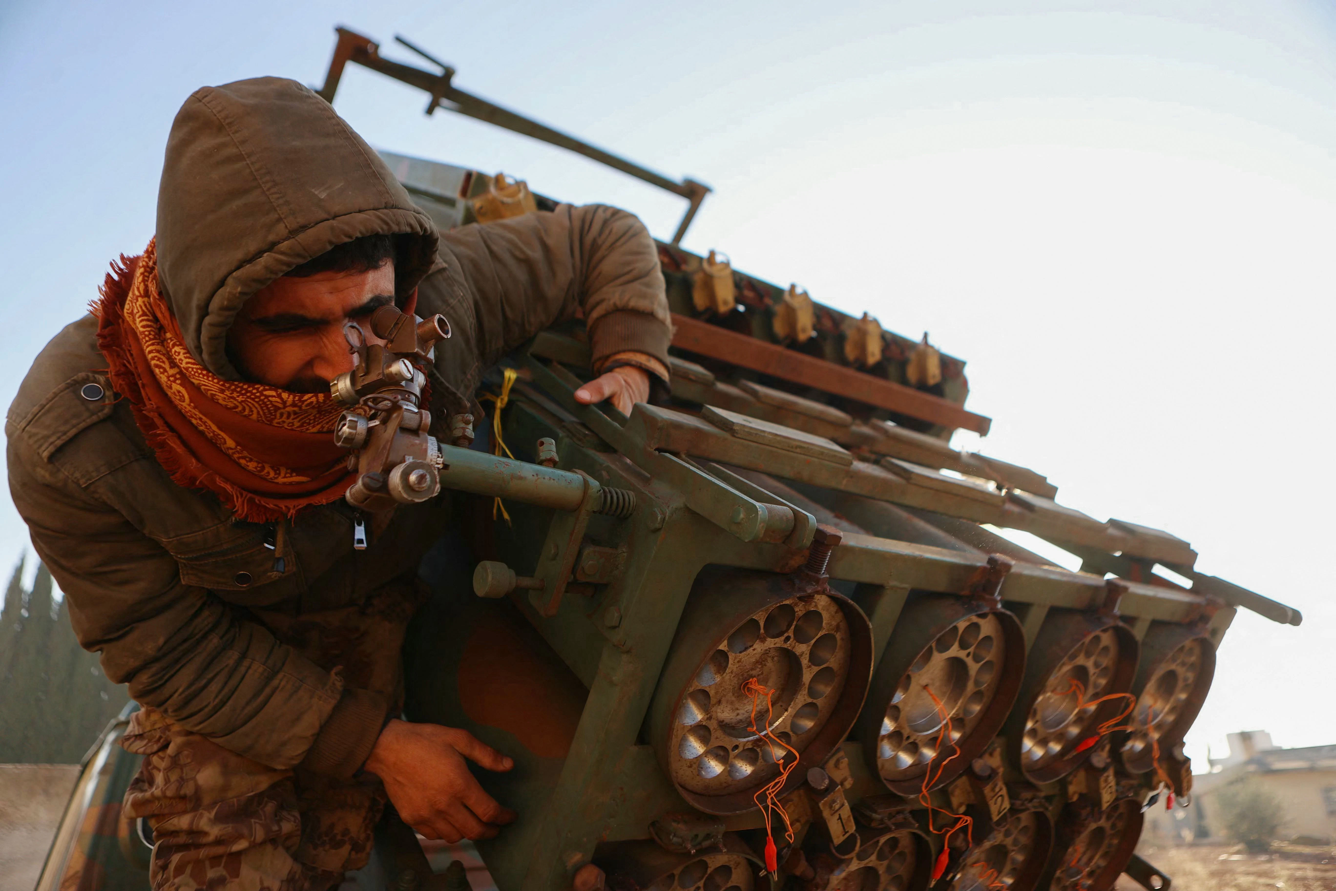 Ein Mitglied der bewaffneten Oppositionskräfte in Syrien inspiziert einen Raketenwerfer der syrischen Armee.