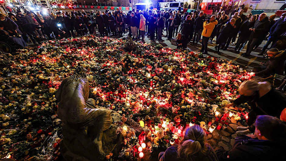 Menschen legen Blumen und Kerzen am offiziellen Gedenkort an der Johanniskirche nieder. Am Vorabend war ein Autofahrer auf dem Magdeburger Weihnachtsmarkt in eine Menschengruppe gefahren. Es gab mehrere Tote und Verletzte.