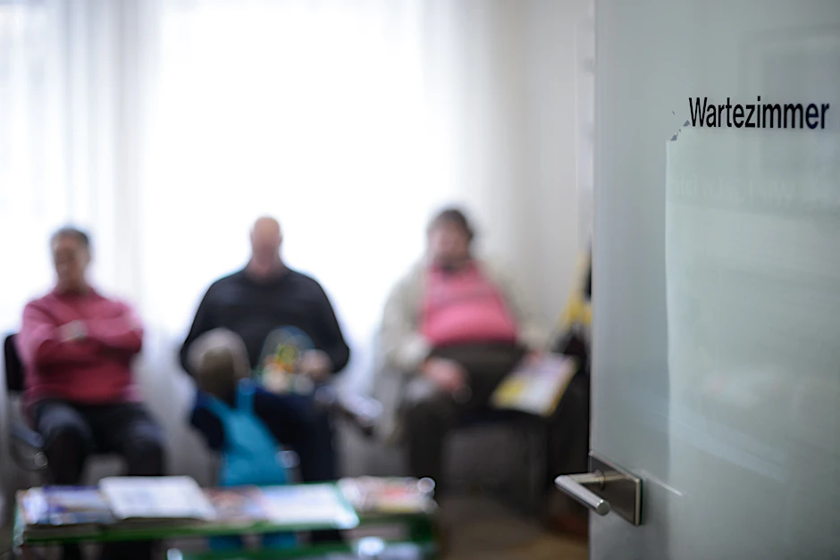 Patienten warten im Wartezimmer einer Arztpraxis.