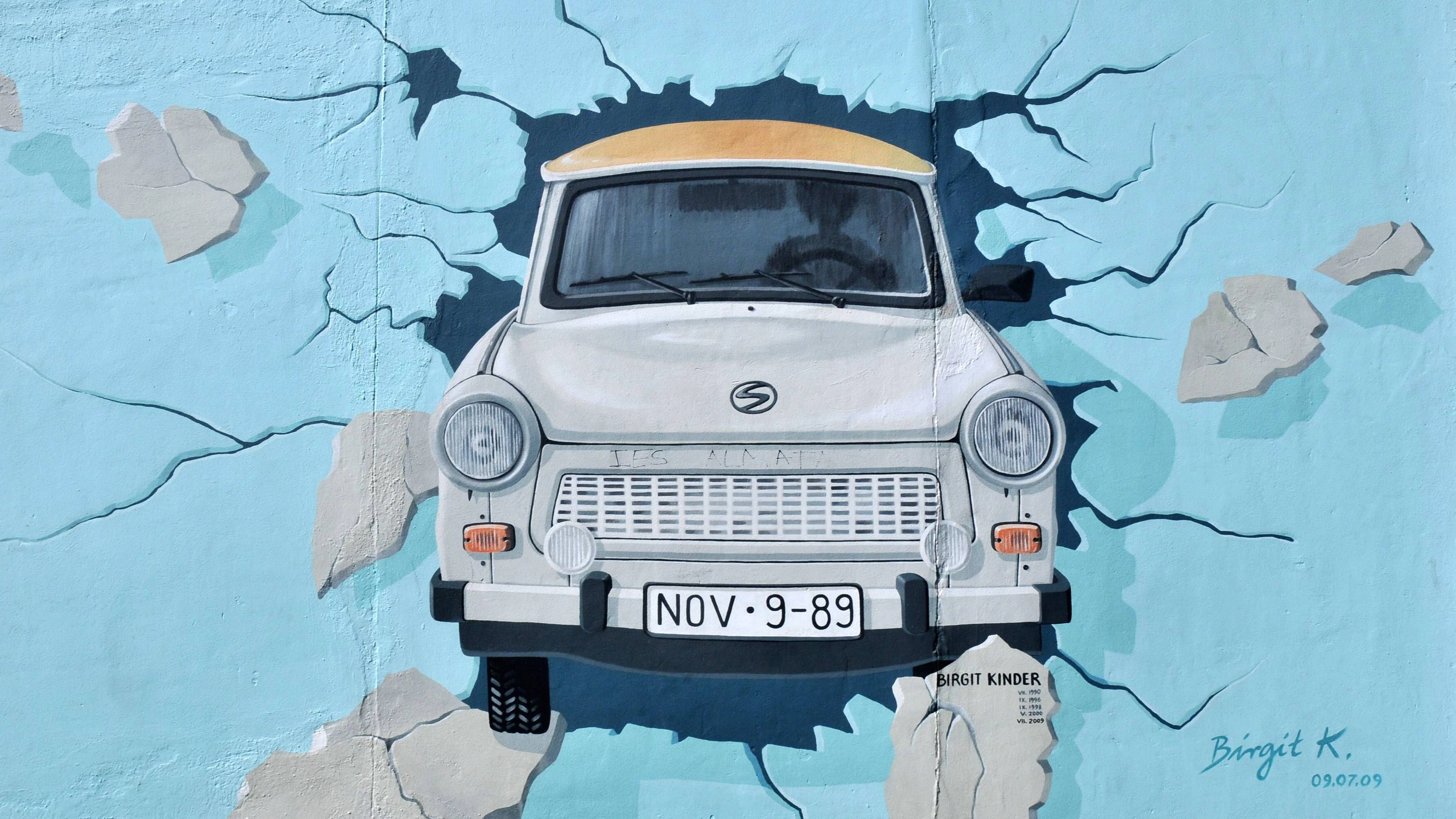 Der kleine Trabi, der durch die Berliner Mauer prescht, ist eines der berühmtesten Gemälde der Berliner East Side Gallery.