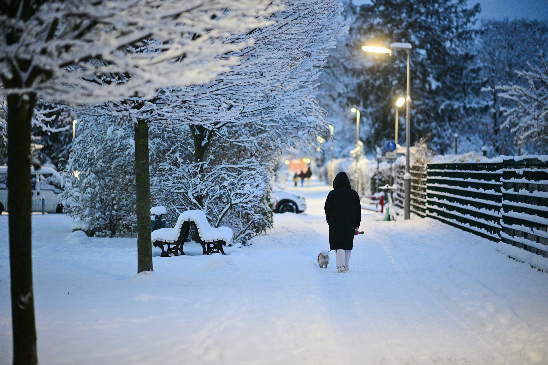 Eine Frau geht durchs Winterwunderland. Berlin versinkt am Morgen im Schnee.