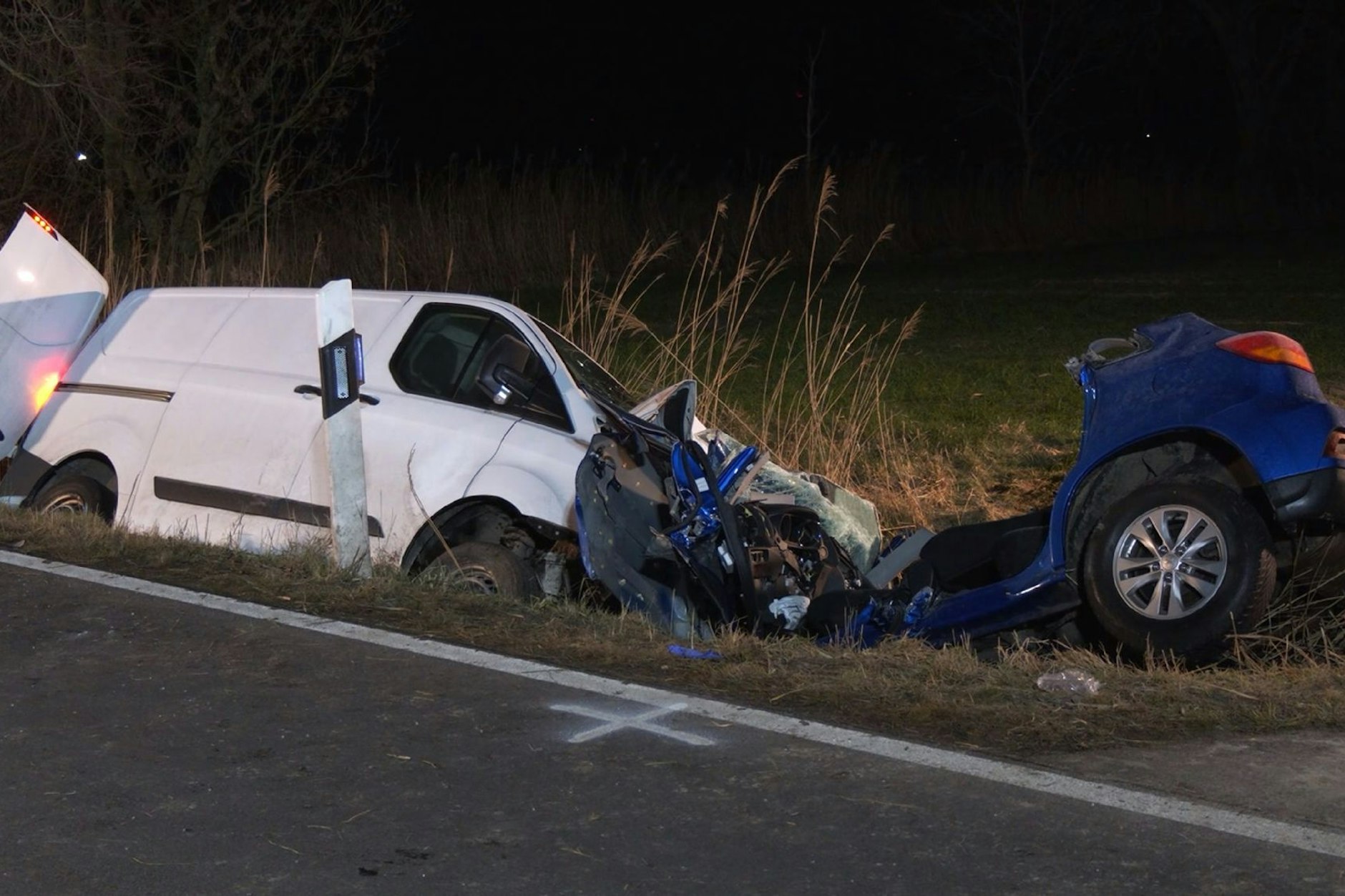Der Kleintransporter und der völlig zerstörte Pkw der Familie liegen im Straßengraben nach einem Unfall, bei dem zwei Menschen in Pewsum starben.