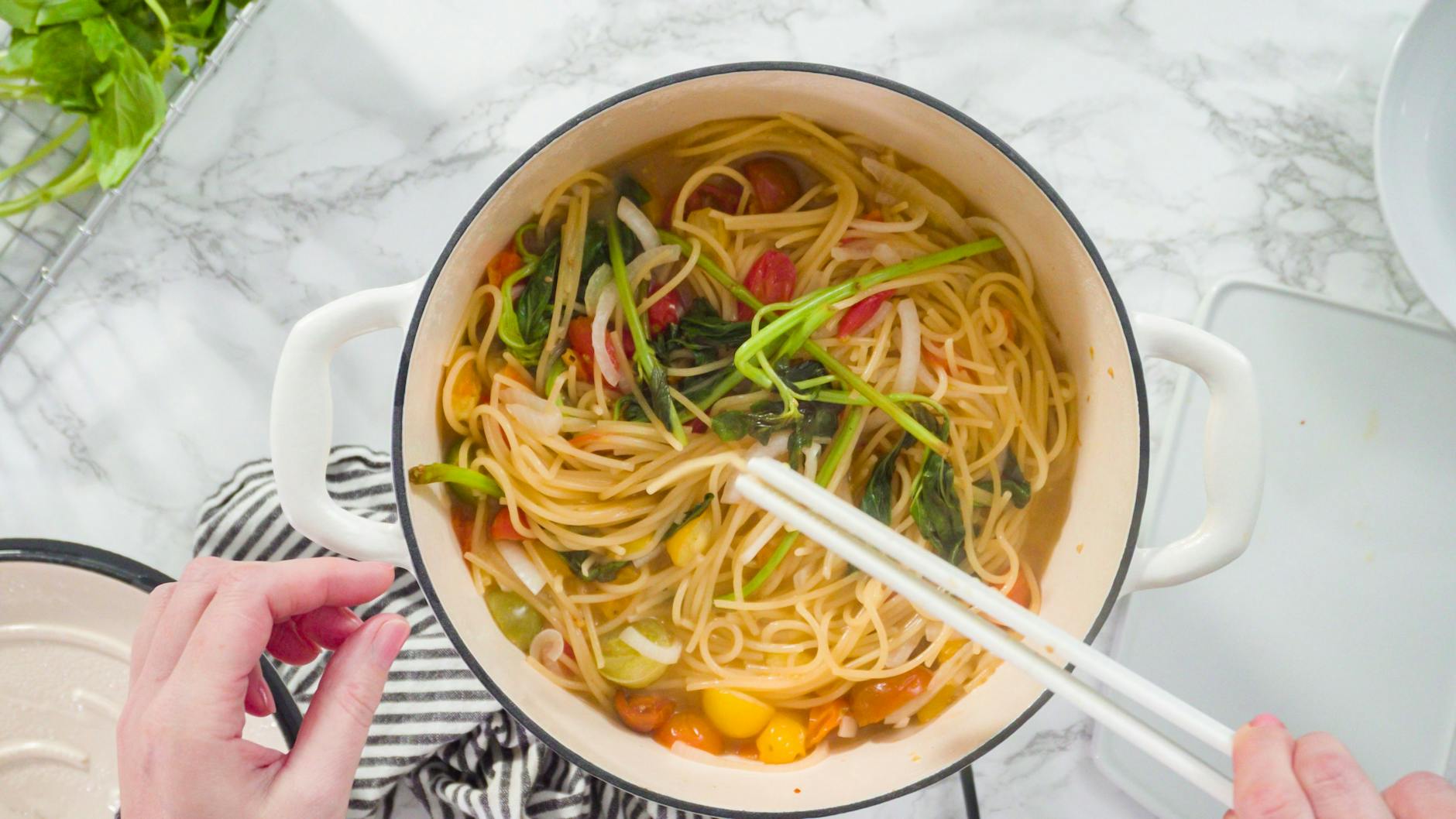 Wenn die Flüssigkeit im Topf von den Spaghetti fast aufgesogen ist, kommen Frischkäse und Parmesan dazu. Zum Schluss die Tomaten.