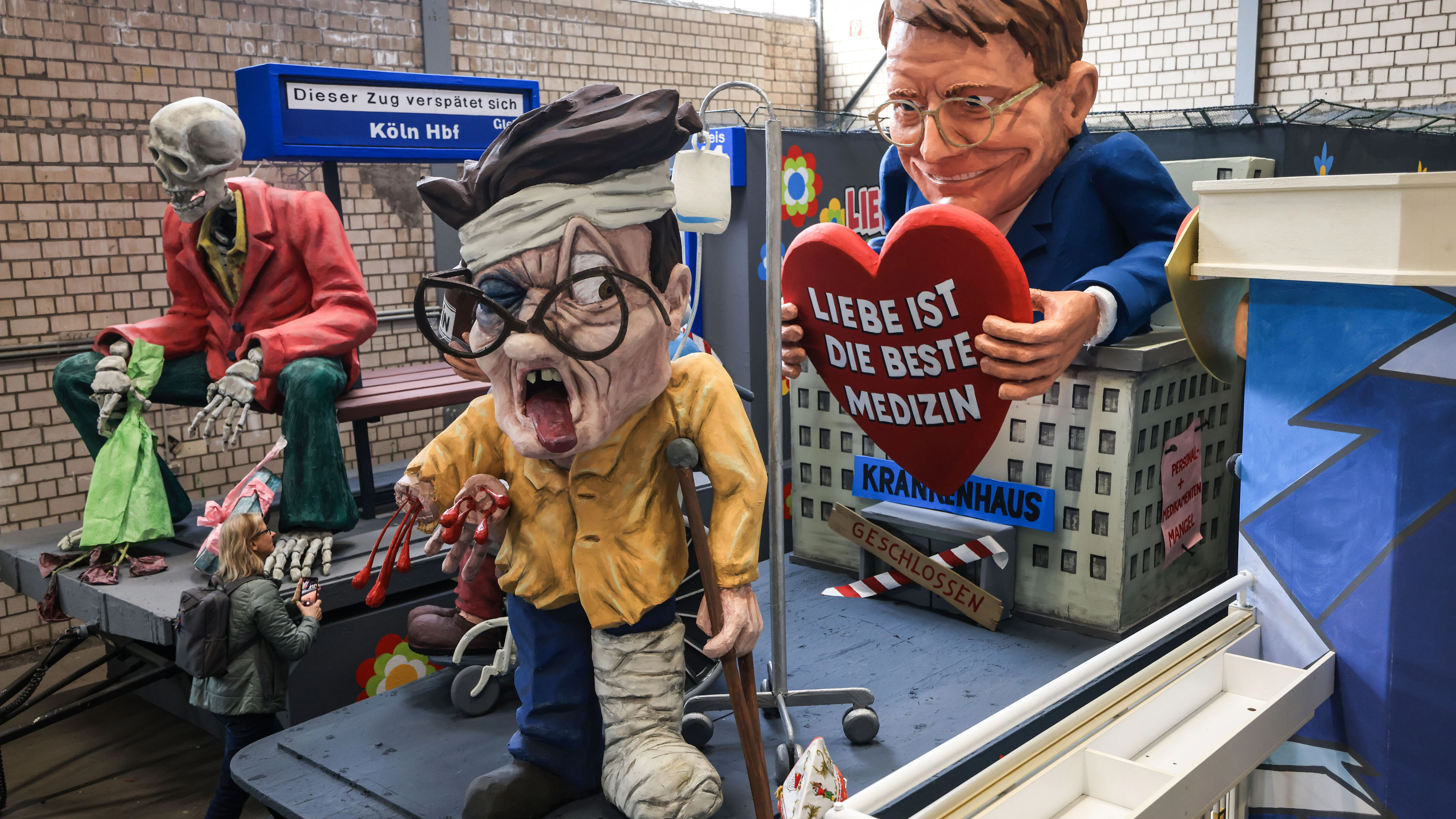 Auf diesem Kölner Motivwagen überbrückt Bundesgesundheitsminister Karl Lauterbach Lieferengpässe bei Medikamenten und Personalmangel im Gesundheitswesen mit dem Rezept „Liebe ist die beste Medizin“ .