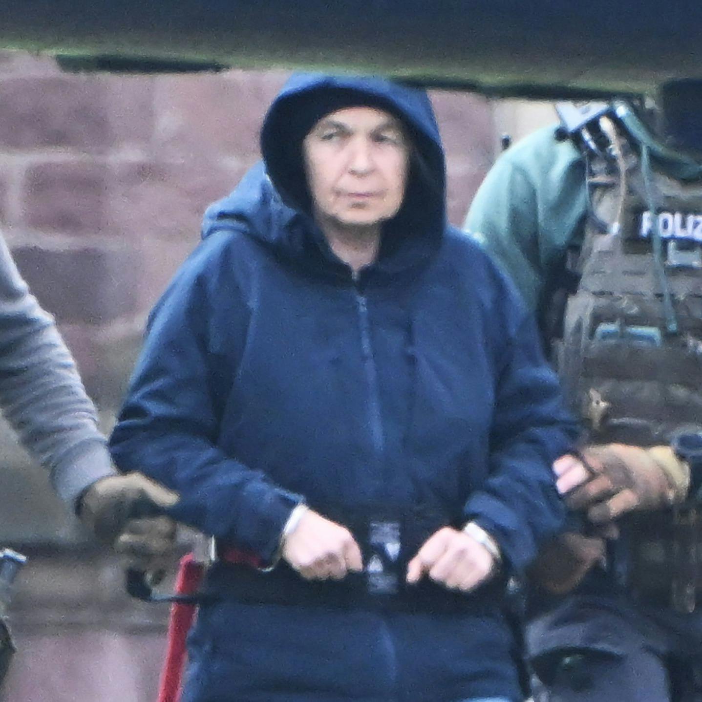 Im Innenhof eines Behördenzentrums wird die frühere RAF-Terroristin Daniela Klette zu einem Hubschrauber geführt.