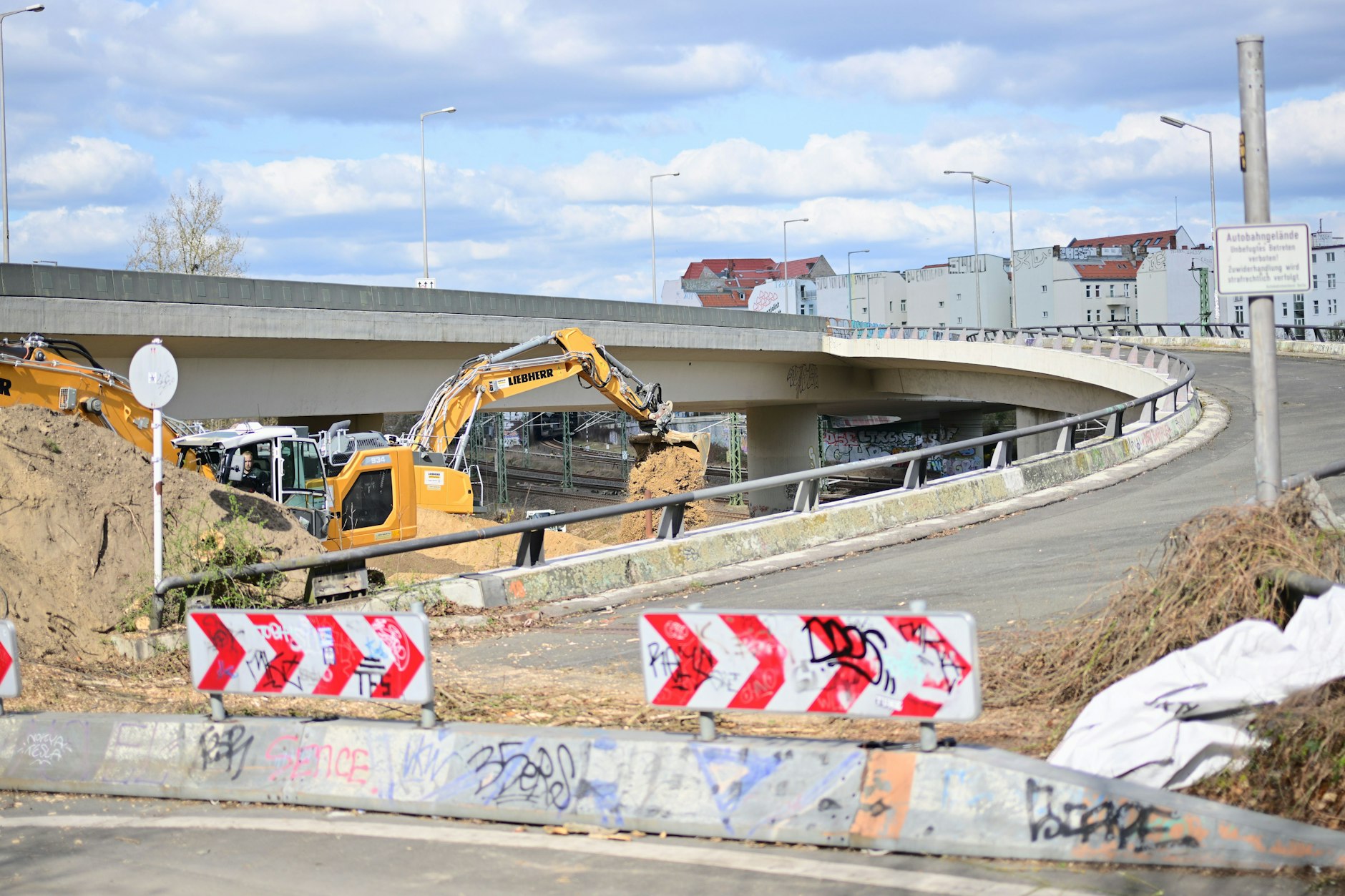 Die Vorbereitungen für den Abriss laufen: Ein Bagger arbeitet an der gesperrten Ringbahnbrücke der A100.