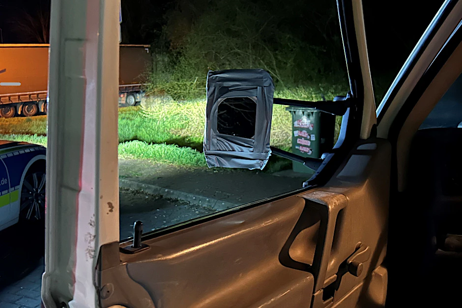 Durch das Fenster des Transporters, das keine Scheibe hat, der Blick auf den Rückspiegel, der eigentlich ein Kosmetikspiegel ist.
