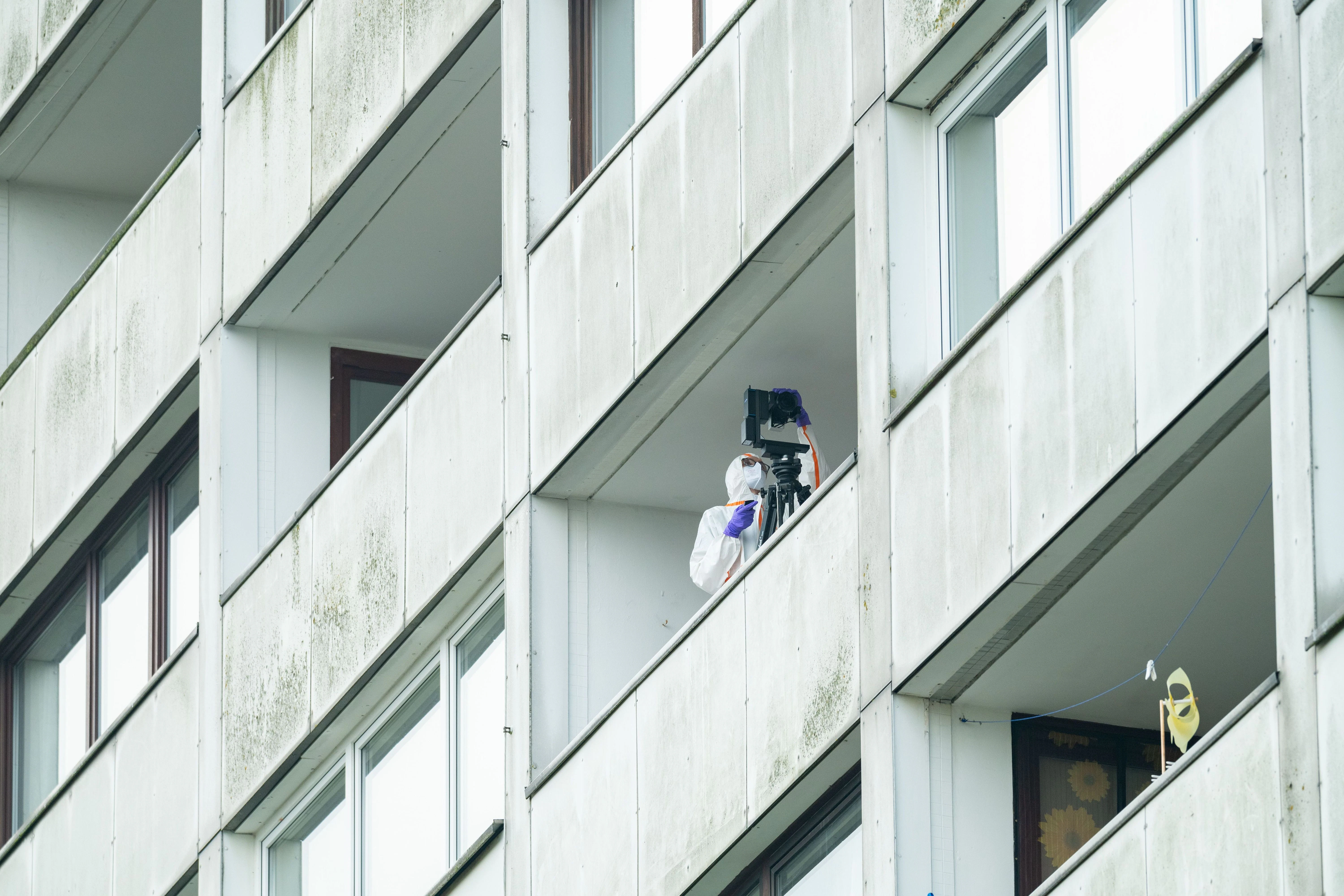Beamte der Spurensicherung ermitteln auf einem Balkon des Hochhauses. Ein junger Mann ist in der Nacht in Hamburg-Wilsdorf vom Balkon eines Hochhauses in den Tod gestürzt. 