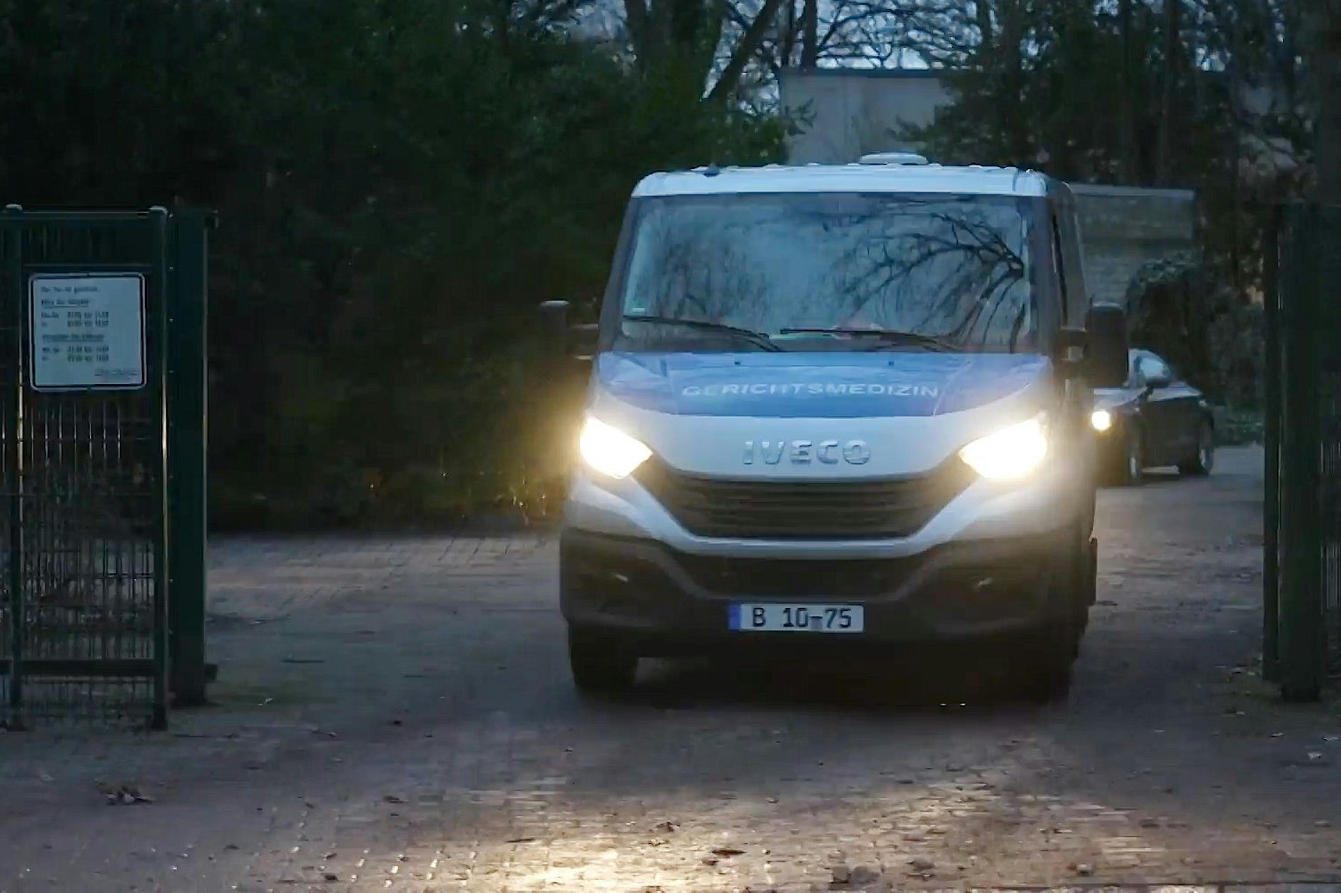 Ein Auto der Gerichtsmedizin verlässt einen Tatort.