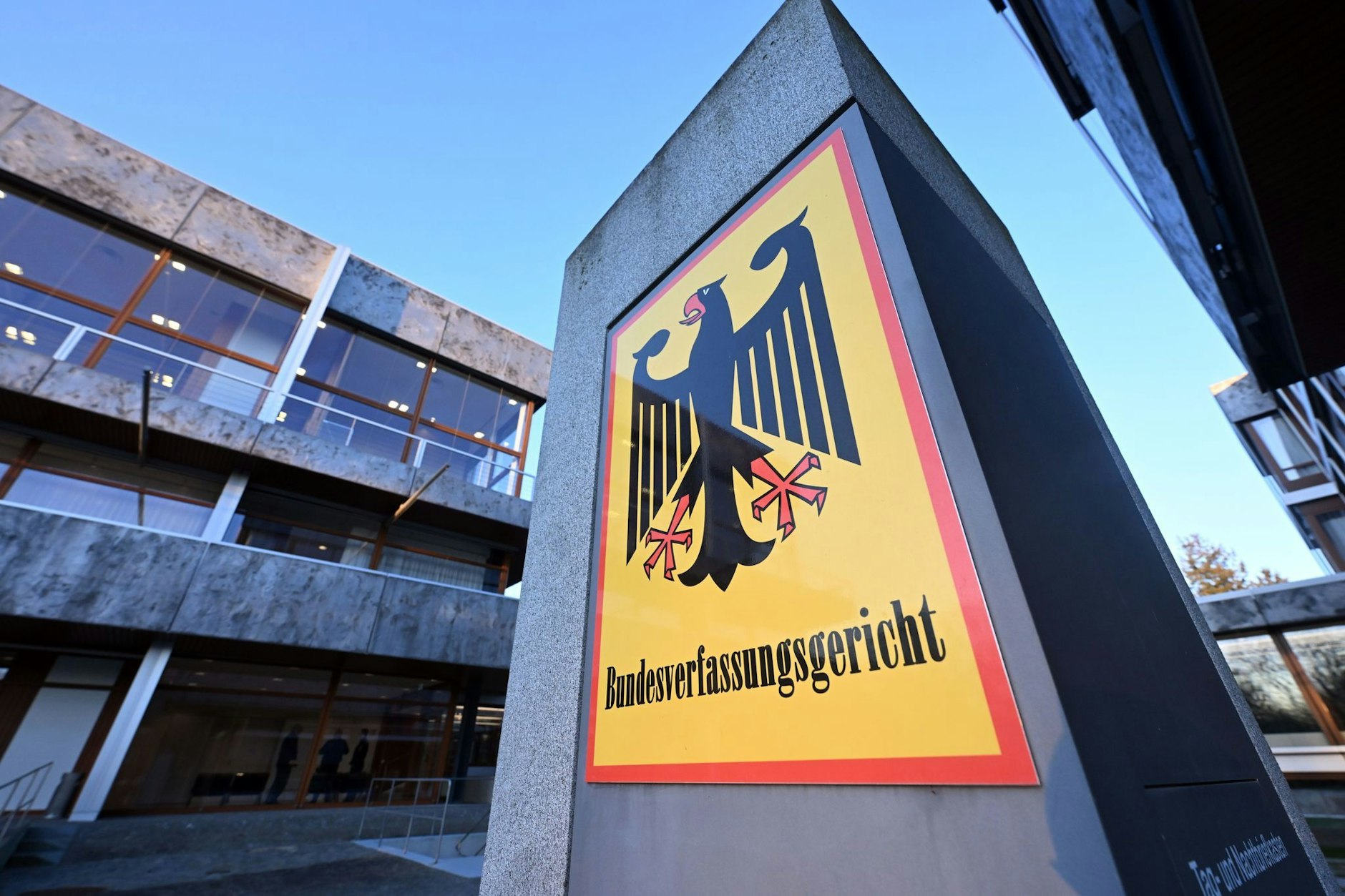 Ein Hinweisschild mit Bundesadler und dem Schriftzug "Bundesverfassungsgericht", aufgenommen vor dem Gericht.