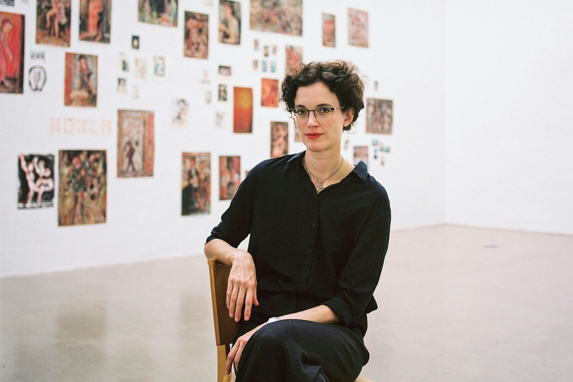 Ulrike Theusner vor Galeriewand mit Zeichnungen